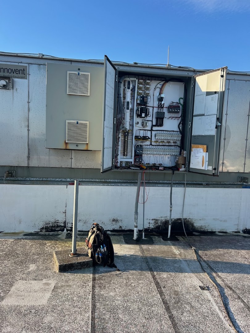 Open rooftop commercial HVAC control panel on a job